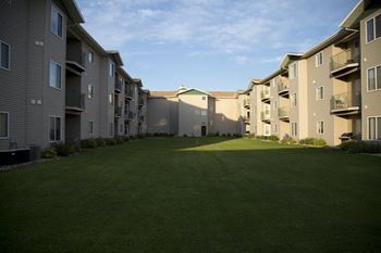 Interior courtyard, freshly cut grass surrounded by Cottonwood Apartments